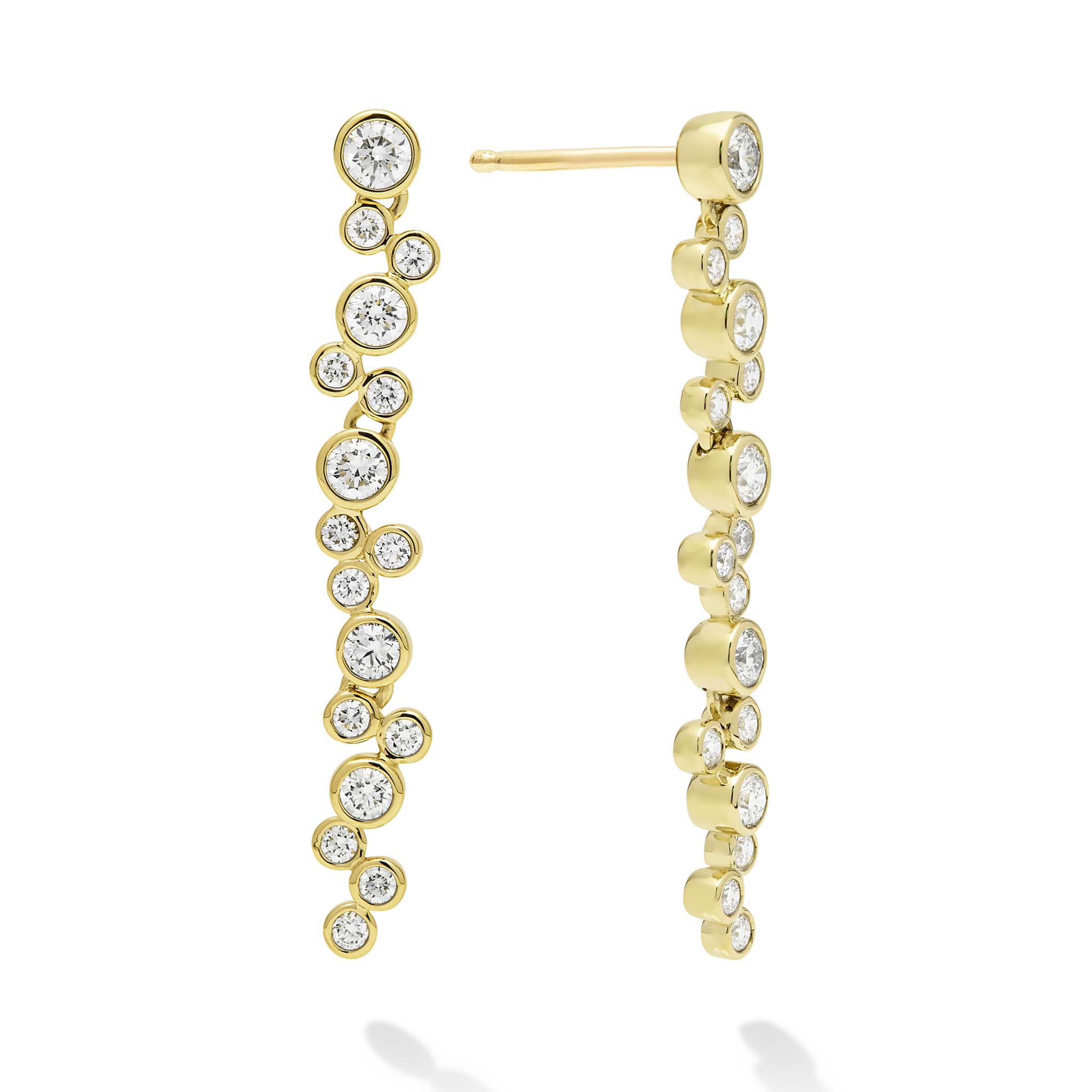 Seventeen bezel-cut diamond drop earrings set in 18K gold on a white background with post