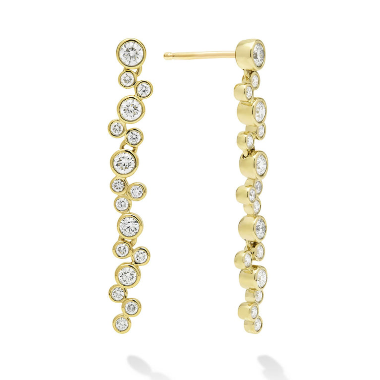 Seventeen bezel-cut diamond drop earrings set in 18K gold on a white background with post