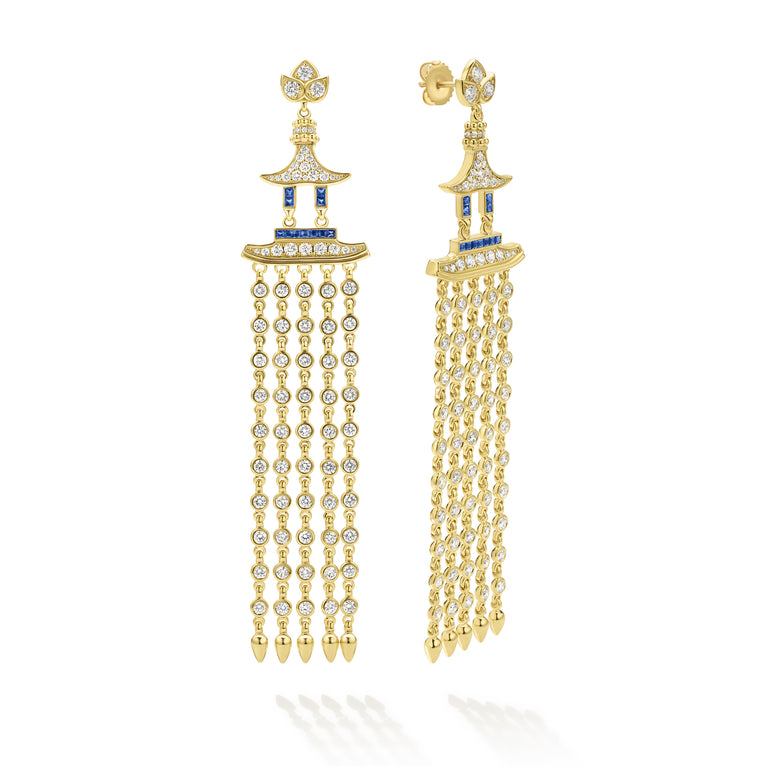 Gold earrings with diamond and blue gemstone accents on a white background