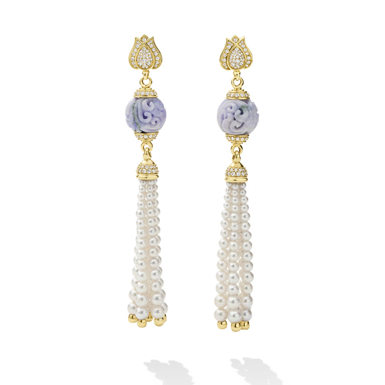 Pair of earrings with gold accents, purple gemstones, and pearl tassels on a white background