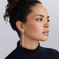 Caviar Icon Two-Tone Caviar Tassel Earrings in silver and gold, featuring intricate beading and tassel design, elegantly accentuating the wearers profile.