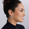 Caviar Icon Sterling Silver & 18K Gold Beaded Triple Hoop Earrings adorn a smiling woman, showcasing elegant craftsmanship with layered hoops and gold accents.