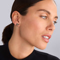Close-up of a person's ear wearing Rare Wonders Honeybee Stud Earrings in sterling silver with gold accents, showcasing intricate bee design and craftsmanship.