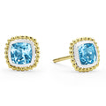 Swiss blue topaz gemstone stud earrings surrounded by smooth sterling silver and 18K gold Caviar beading.