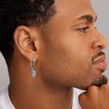 man wearing caviar silver beaded skull drop earring