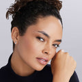 Close-up of a young woman wearing Caviar Spark Silver Linear Diamond Stud Earrings, showcasing their sleek, minimalist design with brilliant diamonds in sterling silver.