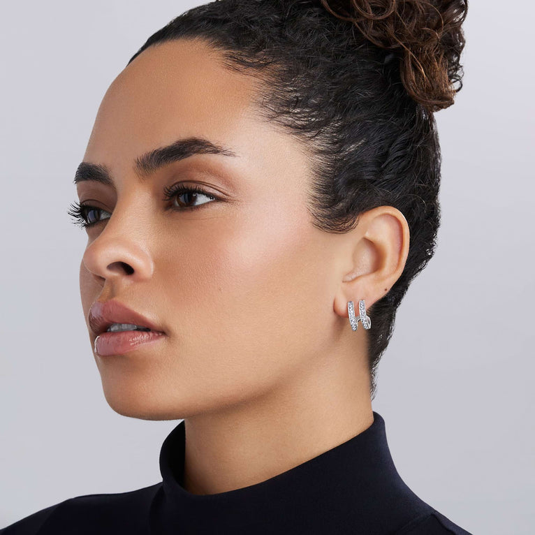 Woman wearing Caviar Spark Silver Linear Diamond Double Row Hoop Earrings, showcasing sleek sterling silver design with double rows of sparkling diamonds, embodying LAGOS elegance.