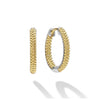 Smooth sterling silver and 18K gold Caviar beading form these signature huggie earrings.