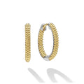 Smooth sterling silver and 18K gold Caviar beading form these signature huggie earrings.