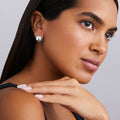 woman wearing sterling silver round huggie earrings