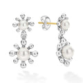 Two cultured freshwater pearls framed by fleurs of sterling silver form these drop earrings.