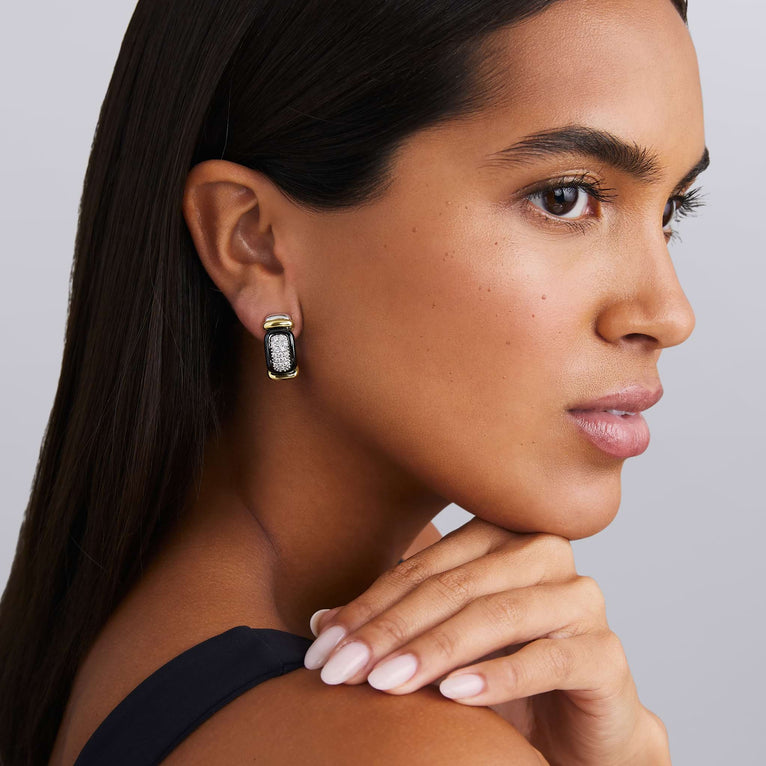 woman wearing sterling silver and black ceramic earrings with diamond details