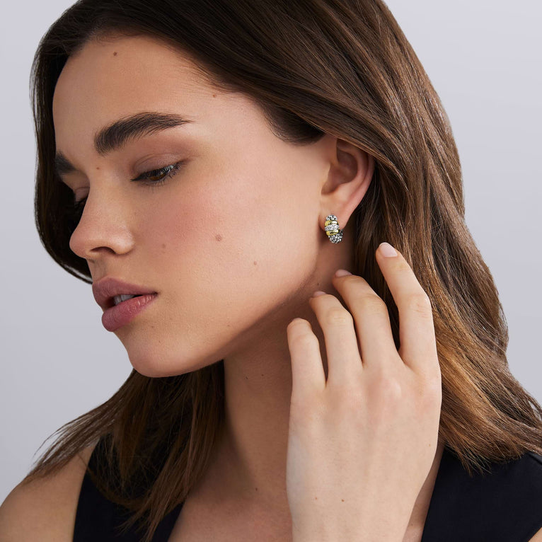 woman wearing sterling silver beaded earrings with gold and diamond details 