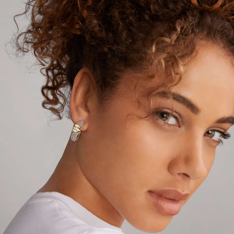woman wearing medium sterling silver beaded hoop earrings with gold and diamond accents