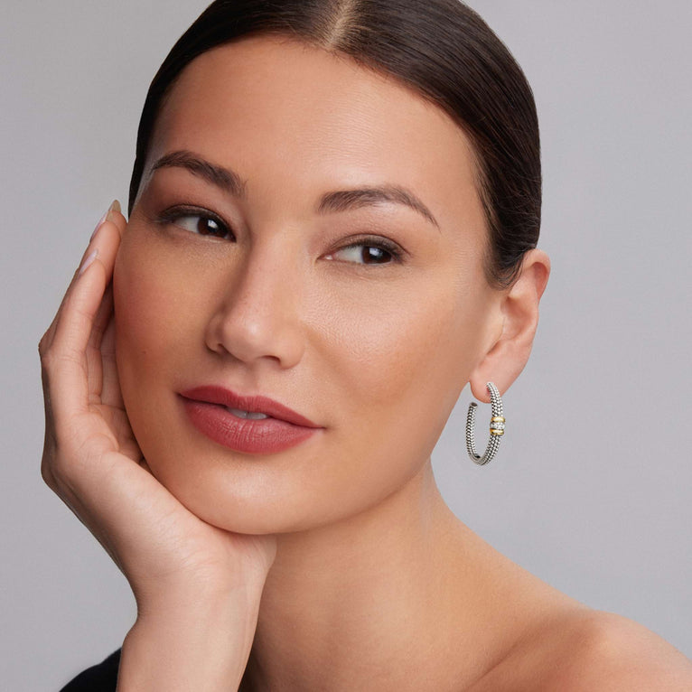 woman wearing large sterling silver beaded hoop earrings with gold and diamond accents