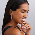 woman wearing sterling silver and gold beaded teardrop earrings with french wire and diamond details