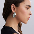 woman wearing large beaded sterling silver hoop earrings