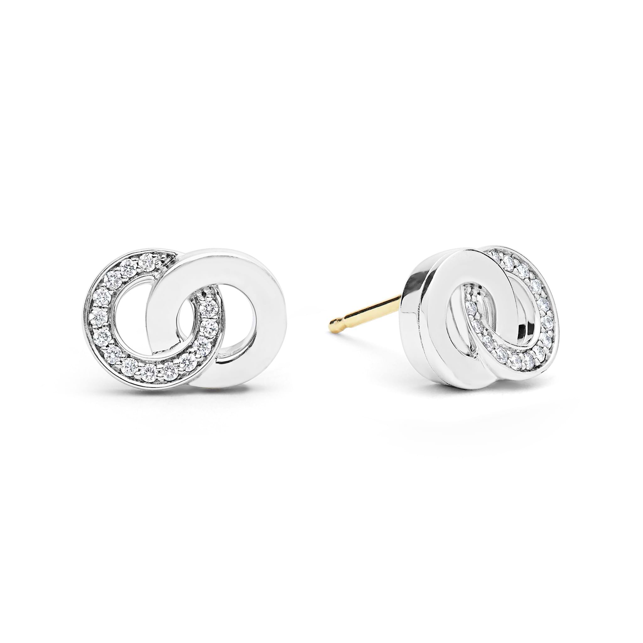 Signature Caviar Silver Interlocking Diamond Stud Earrings feature white metal loops with pavé diamonds and 14K gold posts, showcasing elegant craftsmanship and timeless design.