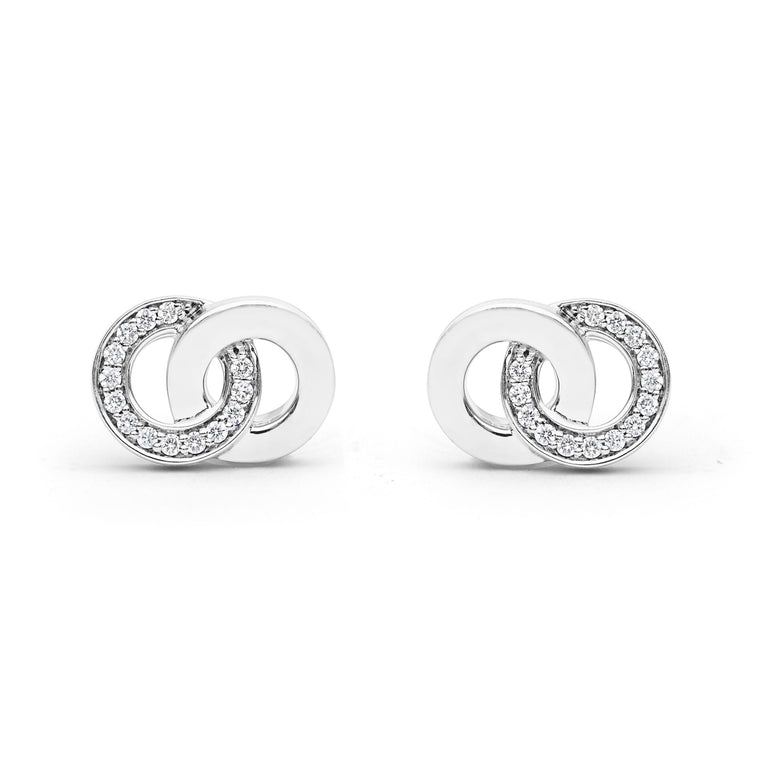 Signature Caviar Silver Interlocking Diamond Stud Earrings feature polished sterling silver loops with pavé-set stones, showcasing elegance and timeless design.