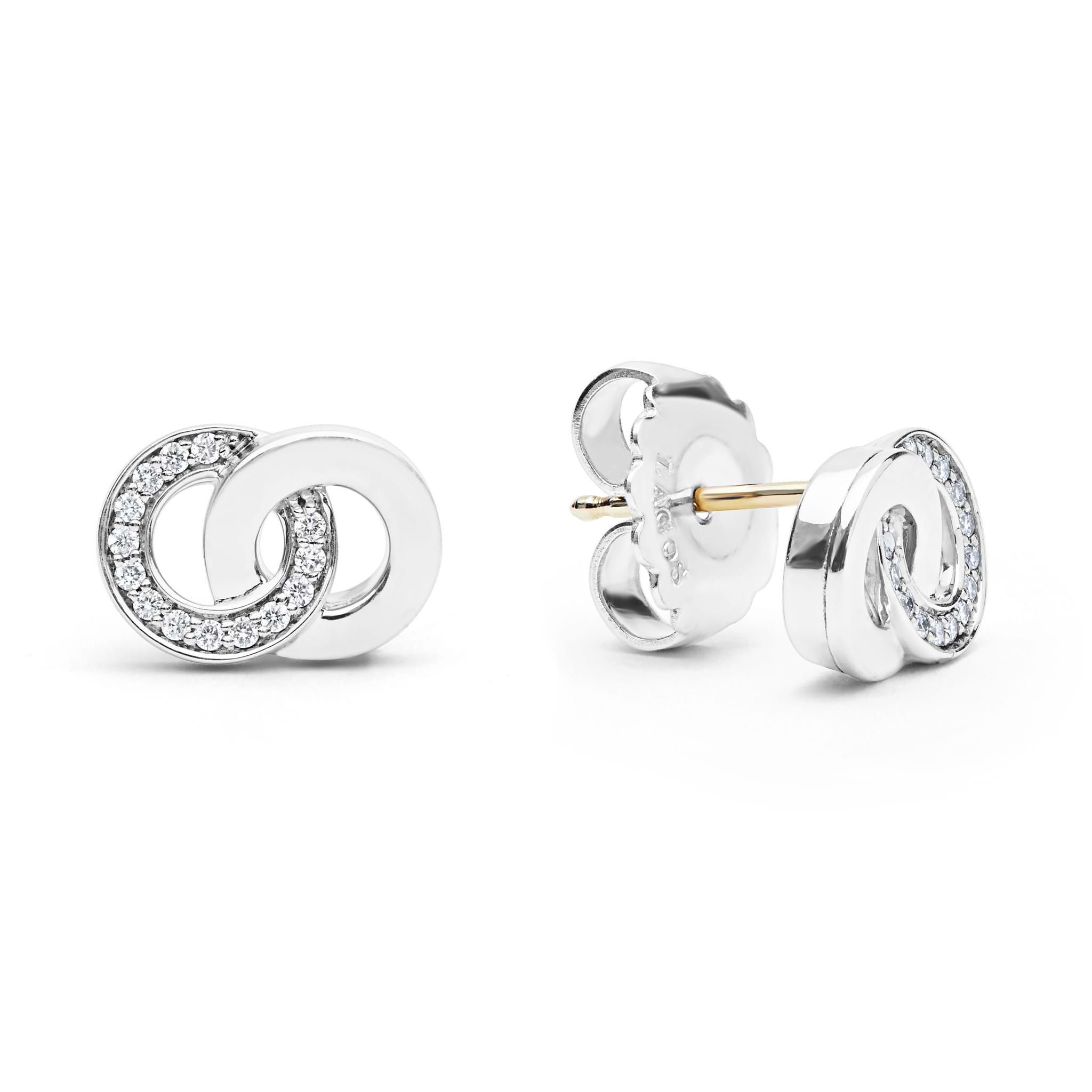 Signature Caviar Silver Interlocking Diamond Stud Earrings featuring polished silver-tone circles with clear stones, gold-colored posts, and butterfly backings, embody timeless elegance and refined craftsmanship.