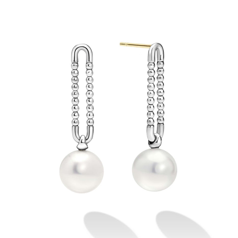 Luna Sterling Silver Pearl Drop Earrings feature silver U-shaped tops with beaded chains and elegant white pearls, showcasing LAGOS modern design and timeless elegance.