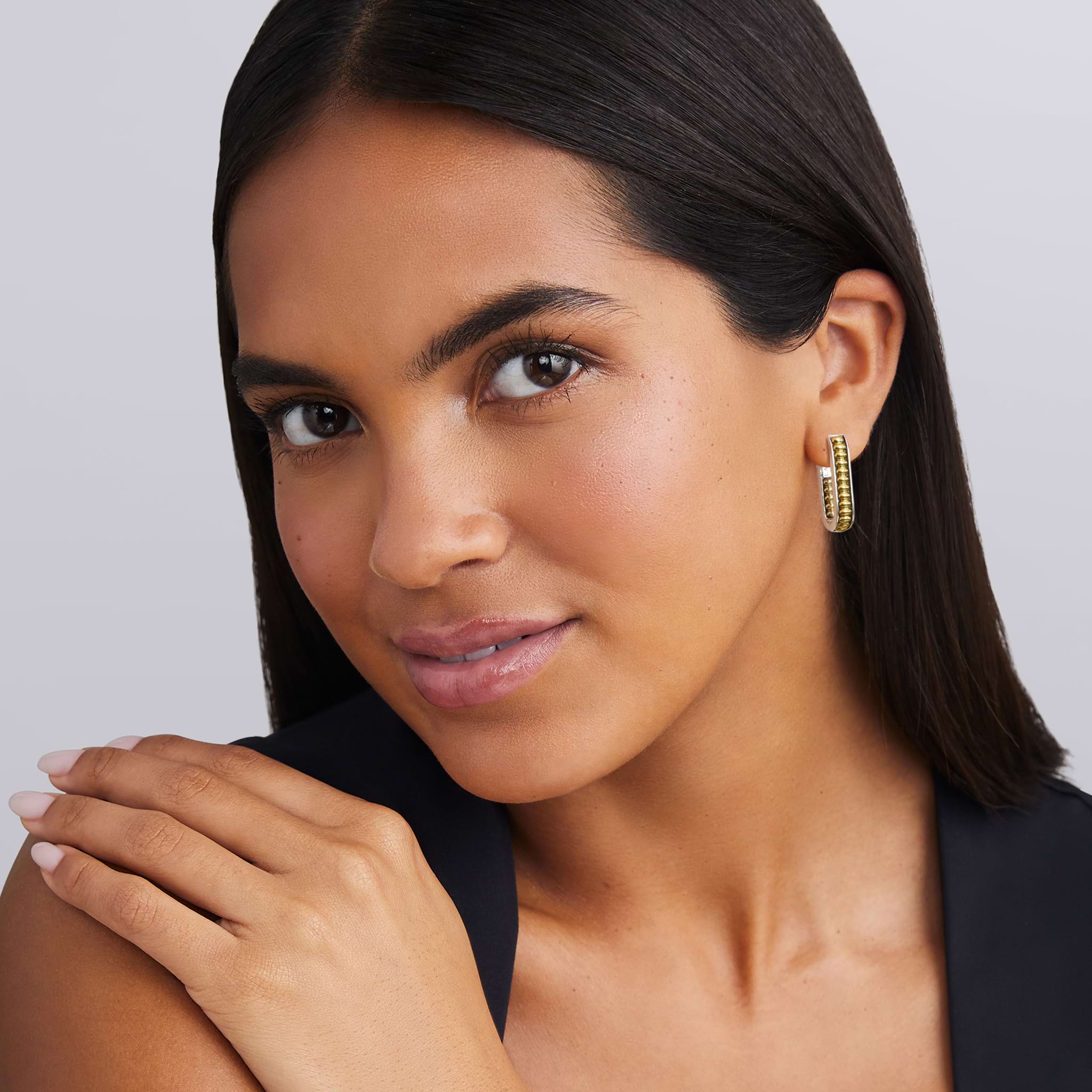 woman wearing everyday gold beaded with sterling silver hoop earrings 
