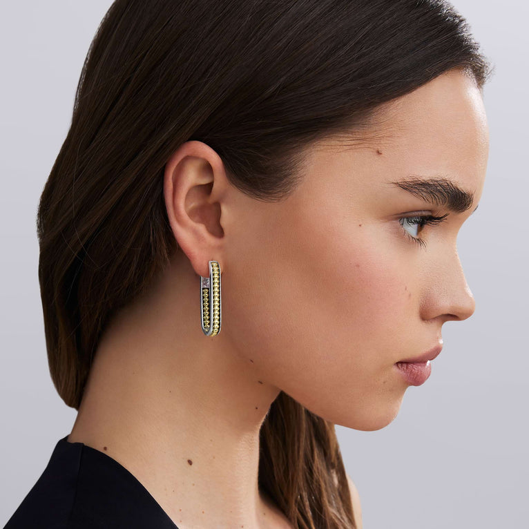 woman wearing large sized everyday gold beaded with sterling silver hoop earrings 