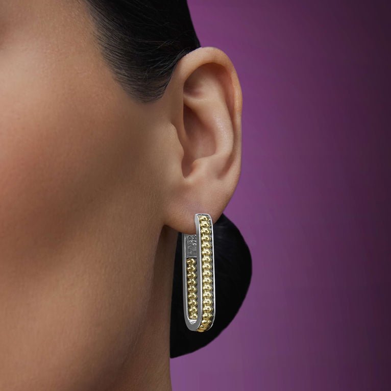 woman wearing large sized everyday gold beaded with sterling silver hoop earrings 