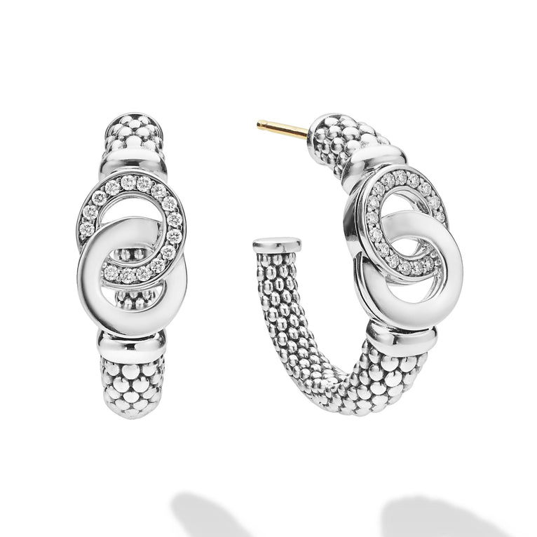 Signature Caviar Silver Interlocking Diamond Hoop Earring displayed with crystal-pave stud earrings, textured ear cuff, and geometric studs on a white background.