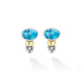 Signature Caviar Two-Tone Swiss Blue Topaz Oval Earrings feature faceted gemstones with silver and gold accents, showcasing LAGOS craftsmanship and elegance.