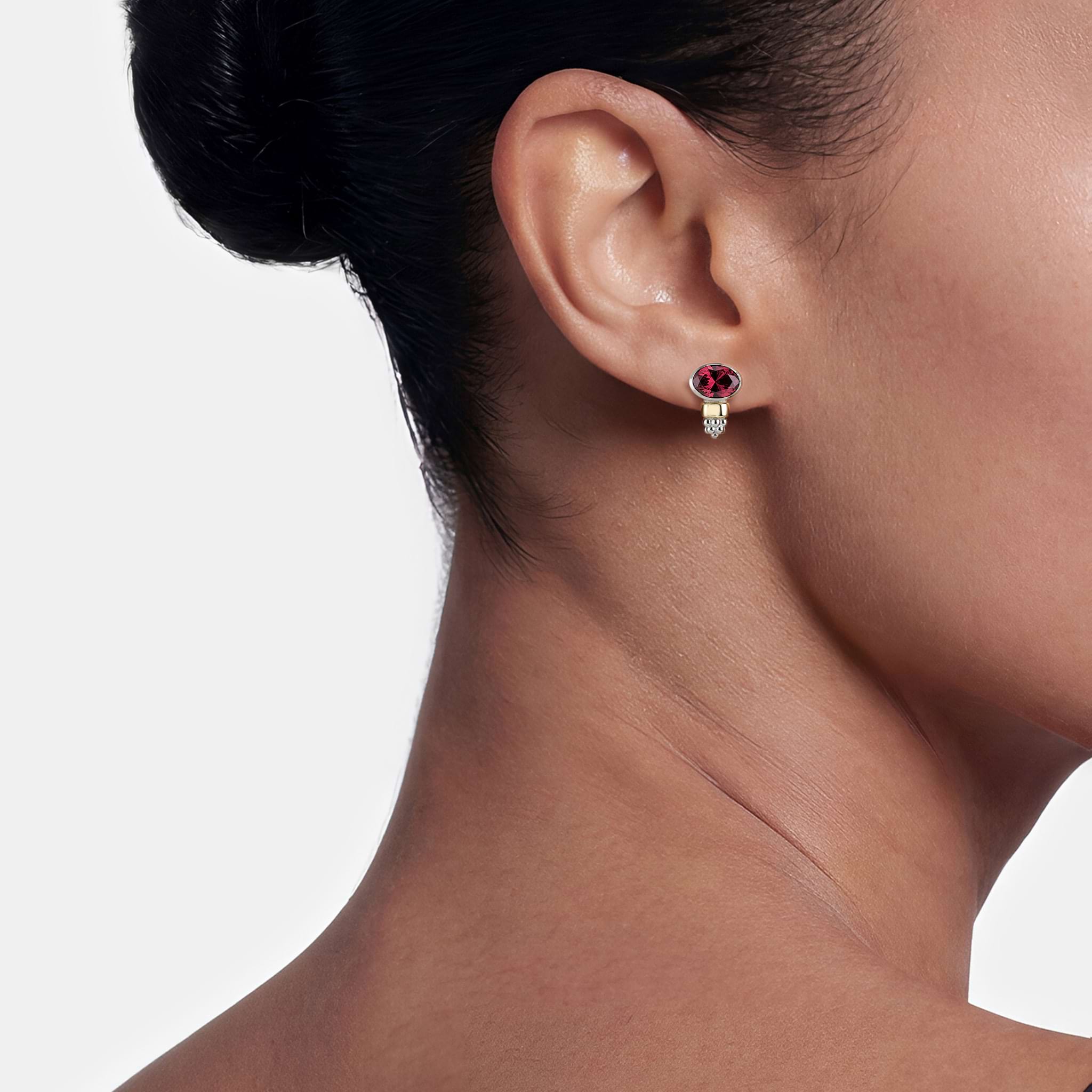 Woman wearing Two-Tone Garnet Oval Stud Earrings
