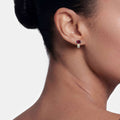 Woman wearing Two-Tone Garnet Oval Stud Earrings