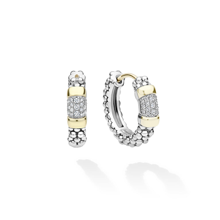 A pair of silver and yellow gold hoop earrings with pavé diamond accents, displayed on a clean white background with soft reflections.