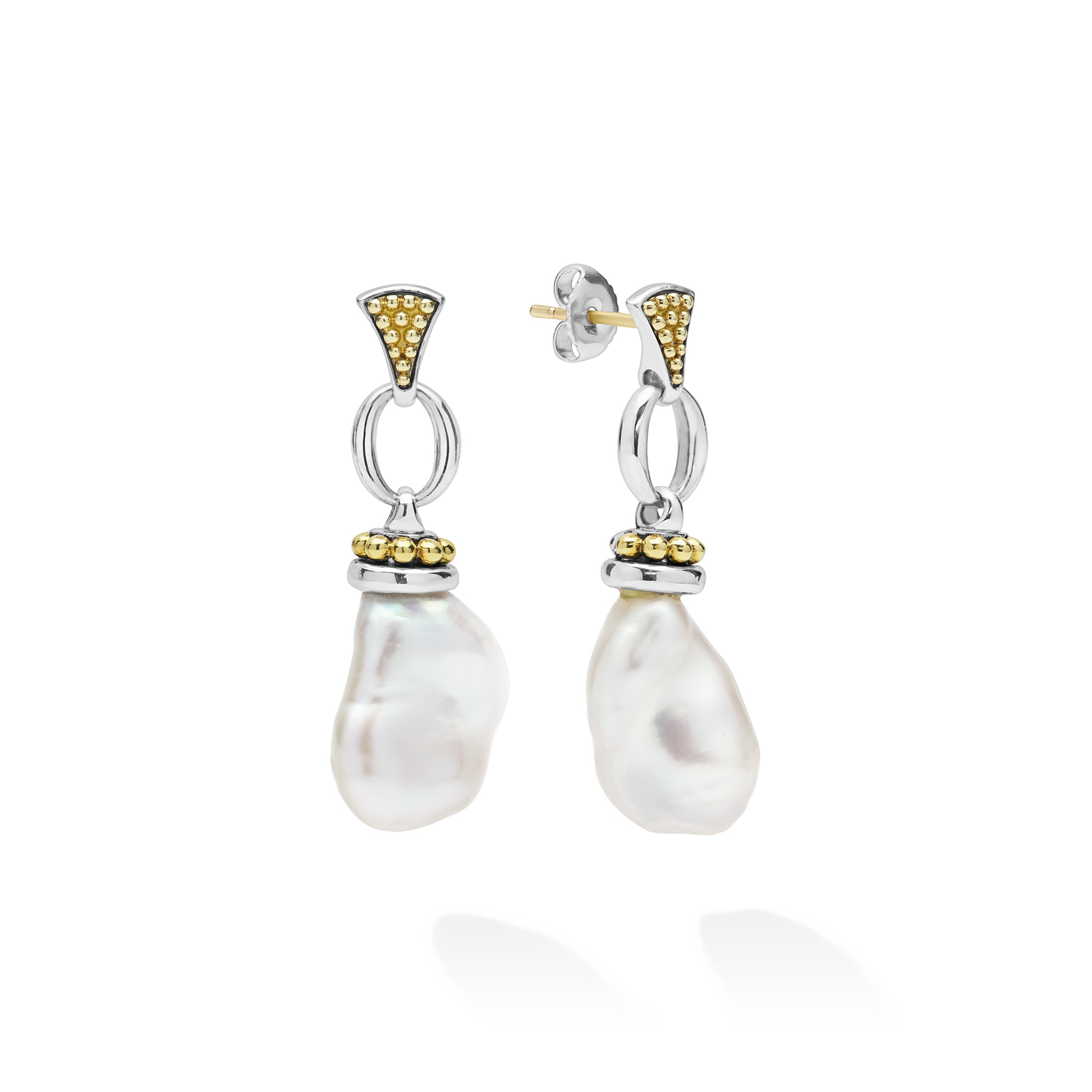 A pair of silver drop earrings featuring irregular white baroque pearls, accented with yellow gold at the top and middle, shown on a clean white background.