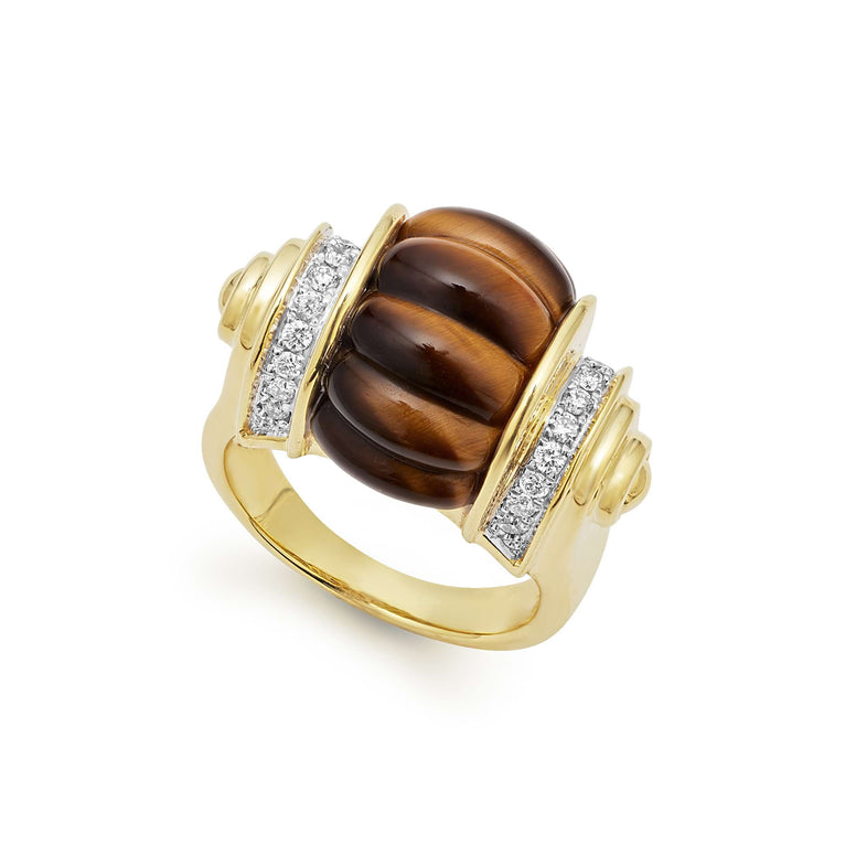 This beautiful ring combines the striking appearence of tigerseye and the brilliant radiance of diamonds. Set in a beautifully crafted 18k gold band.