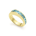 Square cut swiss blue topaz gemstones surrounded by smooth 18K gold form this stacking ring.