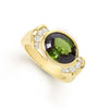 A round green tourmaline gemstone is set in smooth 18k gold and diamonds to form this intricate ring. LAGOS diamonds are the highest quality natural stones.