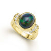 An oval shaped black opal gemstone and round diamonds are set in smooth 18k gold to form this statement ring. LAGOS diamonds are the highest quality natural stones.