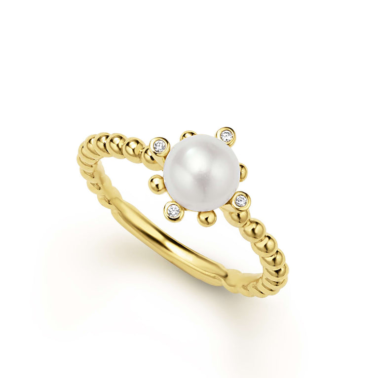Cultured freshwater pearl ring framed by fleurs with diamonds set in 18K gold. LAGOS diamonds are the highest quality natural stones.