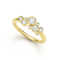 Nine bezel-cut diamond ring set in 18K gold on a white background