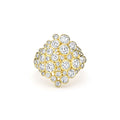 front of cluster diamond set in 18K gold statement ring on white background