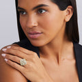 woman wearing cluster diamond set in 18K gold statement ring with black shirt