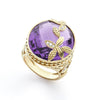 Featuring a magnificant, facete oval-cut amethyst in a deep, royal purple, this ring evokes elegance and sophistication. Delicate gold leaf accents, adorned with sparkling pave diamonds, gracefully wrap around the band all the way up to the amethyst.