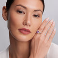 Woman showcasing the Rittenhouse Bezel-Set Amethyst Ring on her manicured hand, featuring a square purple gemstone and 18K Caviar beading.