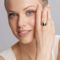 Woman showcasing a Rare Wonders Onyx Beetle Diamond Ring on her middle finger, featuring onyx, diamonds, and 18K gold with sterling silver accents, epitomizing LAGOS craftsmanship.