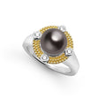 A tahitian black pearl surrounded by 18K gold Caviar beading, sterling silver, and diamonds.