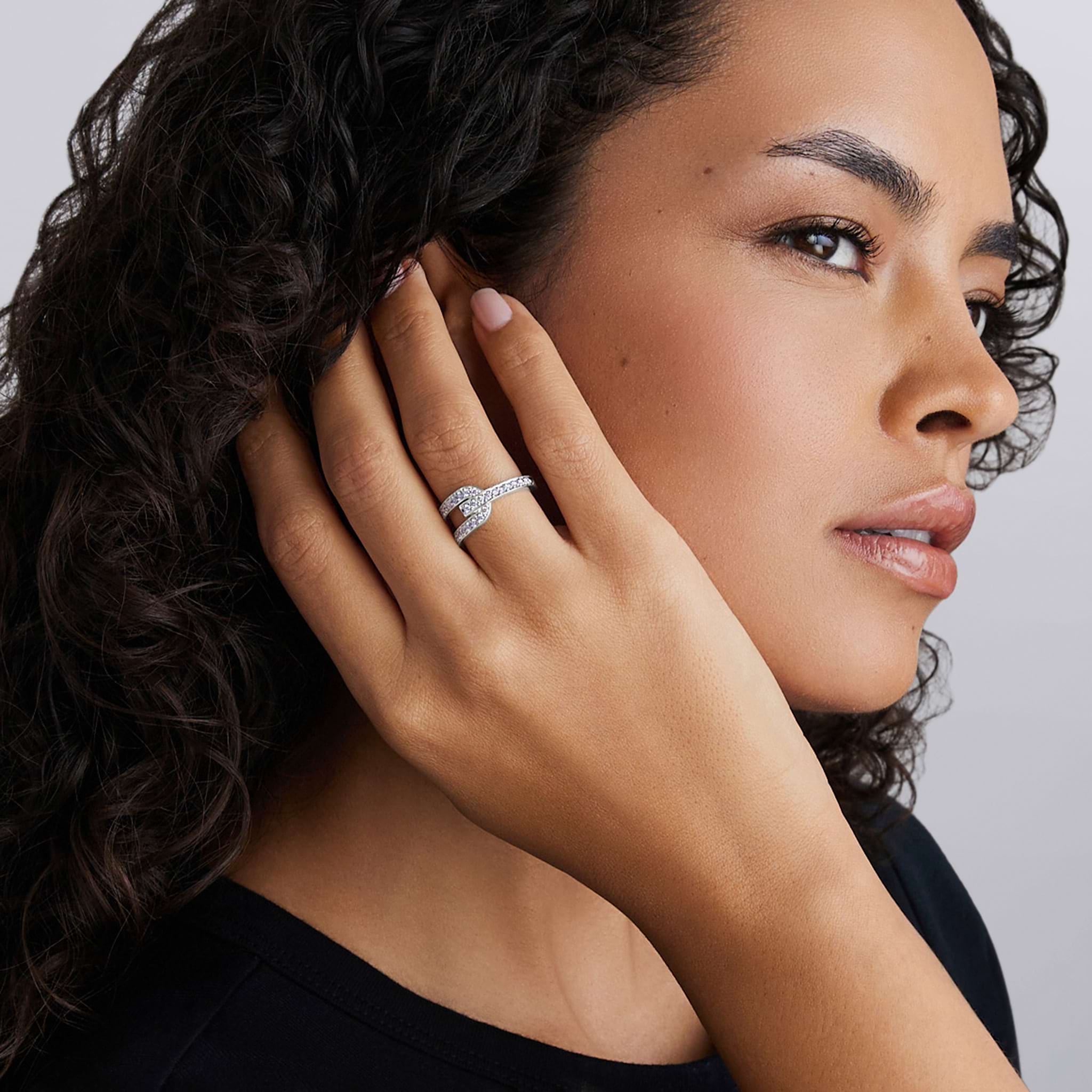 Woman wearing Silver Caviar Linear Diamond Ring with small sparkling stones on her finger, showcasing its sleek design and modern elegance.