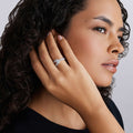 Woman wearing Silver Caviar Linear Diamond Ring with small sparkling stones on her finger, showcasing its sleek design and modern elegance.
