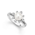 A cultured freshwater pearl framed by sterling silver fleurs and Caviar beading form this ring.