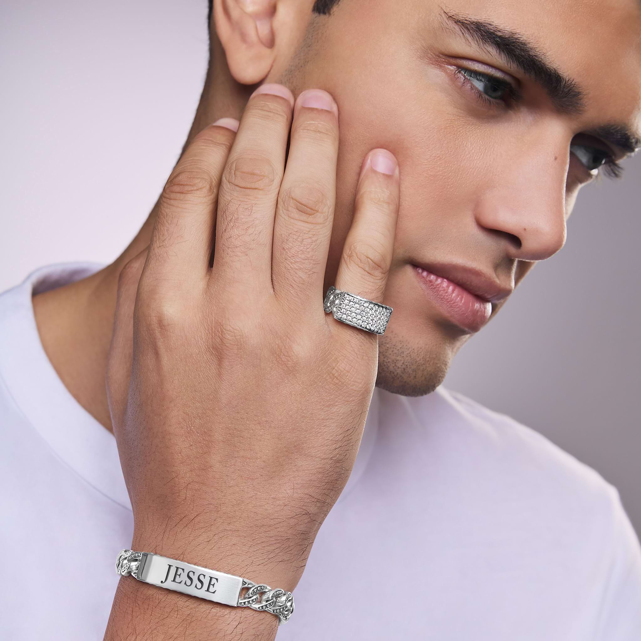Man wearing Anthem collection Caviar beaded sterling silver ring with pavé diamonds, 12 mm band